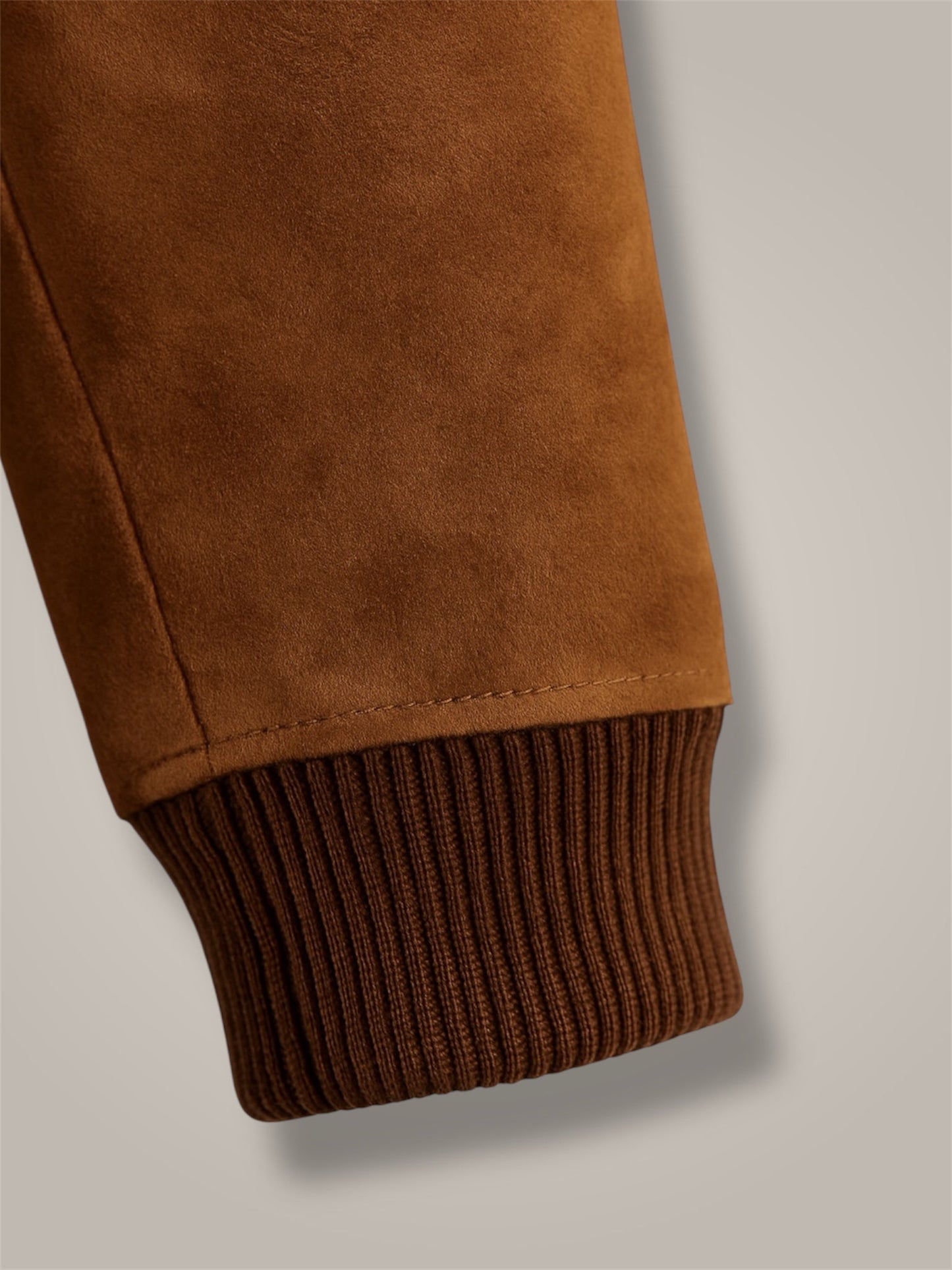 Brown textured fabric with ribbed hem on a light gray background